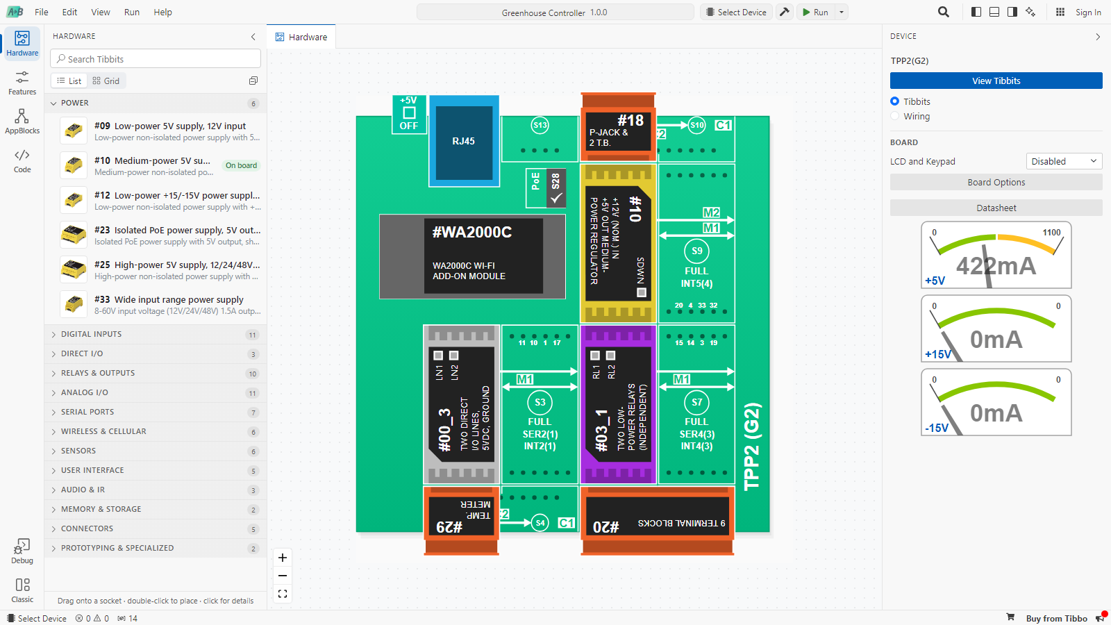 The Hardware step for a TPP2(G2). The Tibbit library is on the left, the board in the middle shows a power regulator, a Wi-Fi module, a relay Tibbit, a direct I/O Tibbit with a temperature meter and terminal blocks, and the Device sidebar on the right shows power meters for +5V, +15V and -15V.